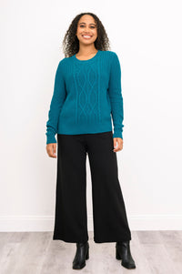 Front-facing view of a women's dark turquoise knit top and loose pants, showcasing a cozy weekend outfit look.