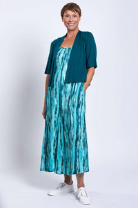Woman with teal cardigan over Aqua Breeze striped sleeveless jumpsuit