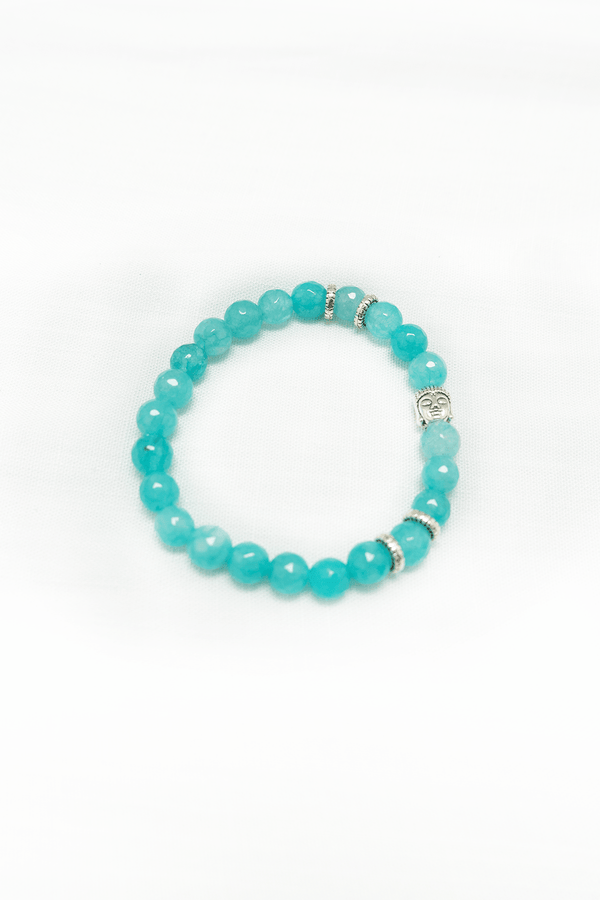 Aquamarine bead bracelet with silver accents and a Buddha charm on a white background