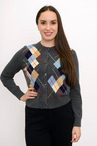 Woman wearing multicolor argyle knit sweater with black pants on a white background, front view