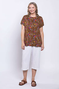 Front facing model in Aria Tee, brown with colorful florals, styled with white culottes