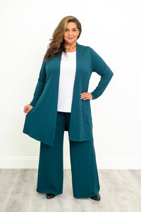 Straight-on full body view of a women's teal French terry duster jacket styled with wide-leg trousers.