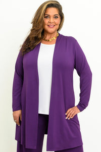 Front view of a smiling woman wearing an open royale purple long-line bamboo cardigan over a white top.