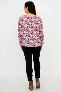 Back view of woman wearing floral bamboo top and black pants
