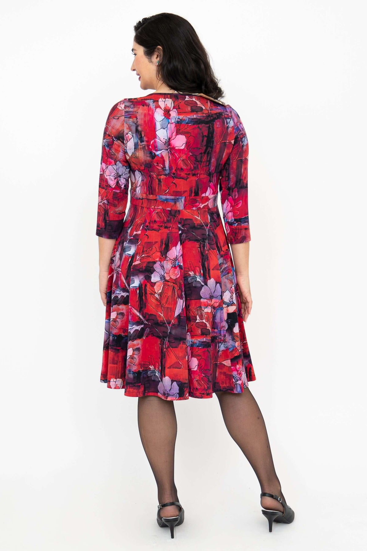 Back view of woman wearing a red and purple floral fit and flare dress