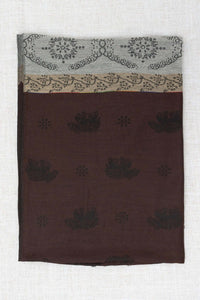 Reverse side of pashmina scarf showing brown base with subtle dark floral patterns and borders