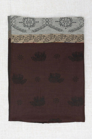 Reverse side of pashmina scarf showing brown base with subtle dark floral patterns and borders