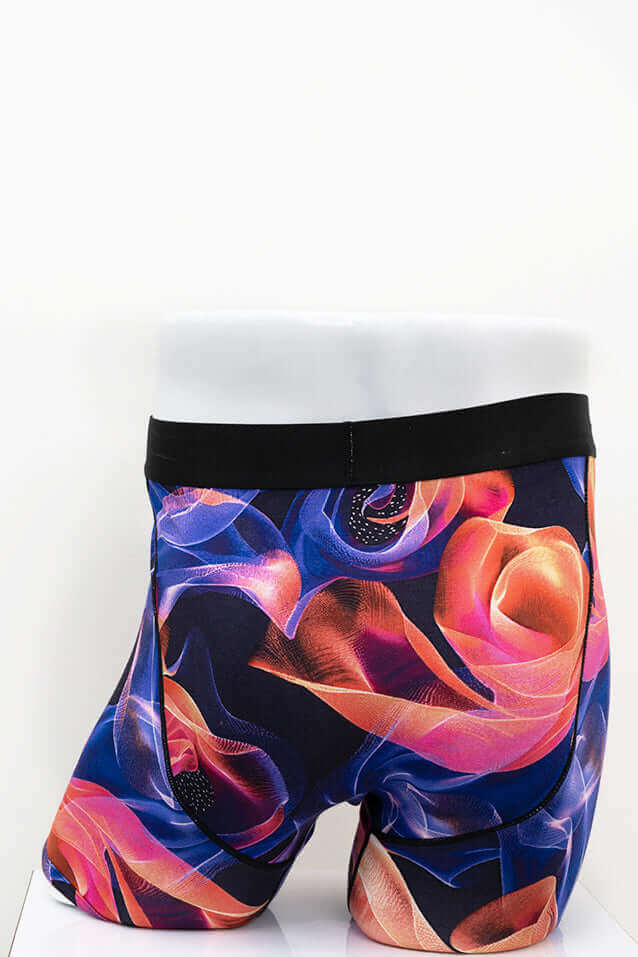 Back view of Middle Man men's boxer briefs with vibrant abstract rose pattern and black waistband