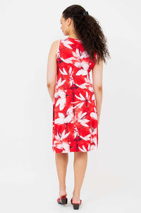 Back view of sleeveless red and white floral pleated dress on model