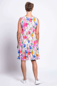 Back view of woman wearing sleeveless, bright floral Willow Dress