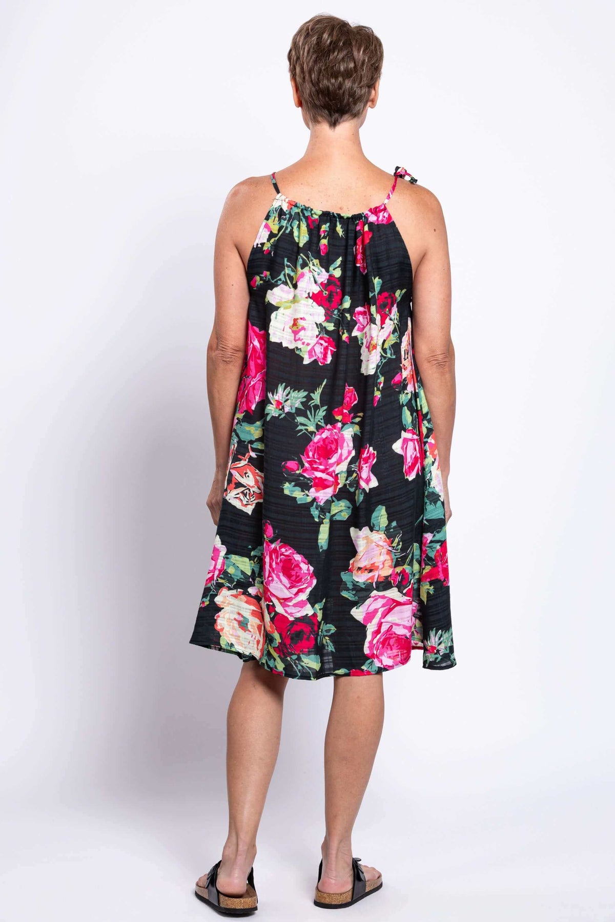 Back view of floral print beach dress with single tie strap detail