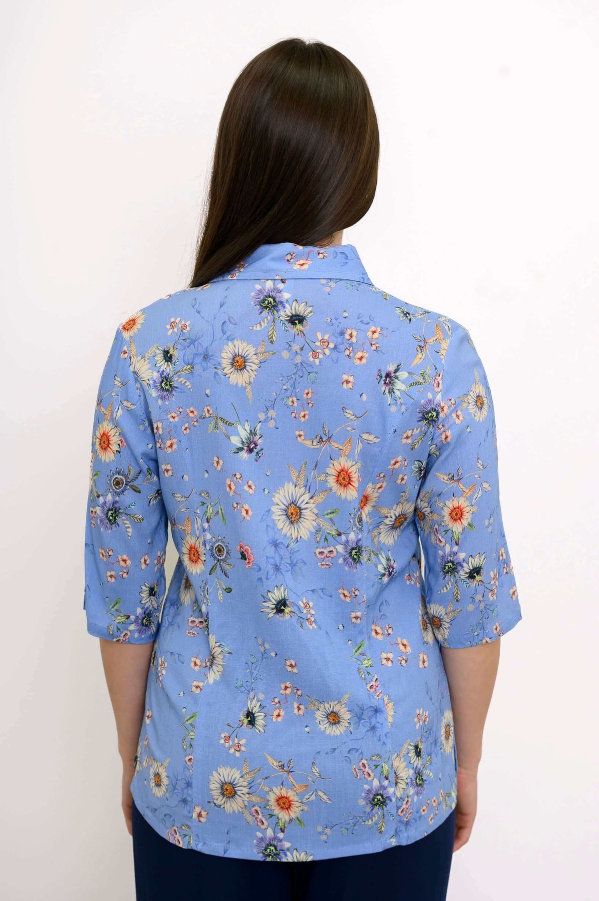 Back view of blue floral blouse showing shirt collar and floral pattern