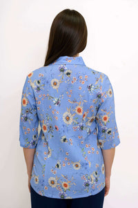 Back view of blue floral blouse showing shirt collar and floral pattern