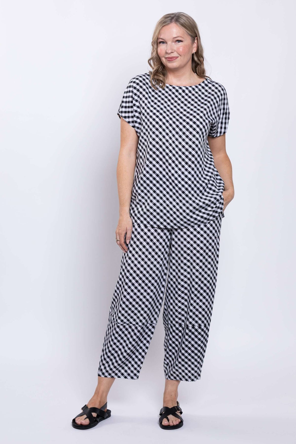 Back view of a woman wearing the gingham linen blend tee and pants set