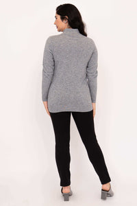 Back view of woman wearing a grey long sleeve mock neck sweater with a hi-lo hem