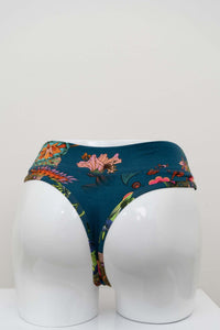 Back view of high rise bamboo thong with bold floral design on white mannequin