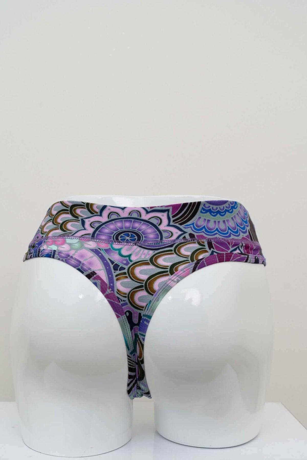 Back view of high rise bamboo thong underwear in purple geometric print on mannequin