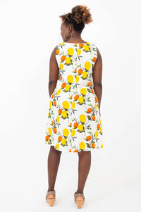 Back view of woman in sleeveless citrus fruit print shift dress