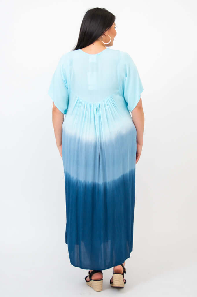 Back view of woman in ombre blue tiered maxi dress, highlighting gradient design