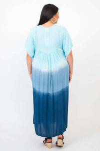 Back view of woman in ombre blue tiered maxi dress, highlighting gradient design