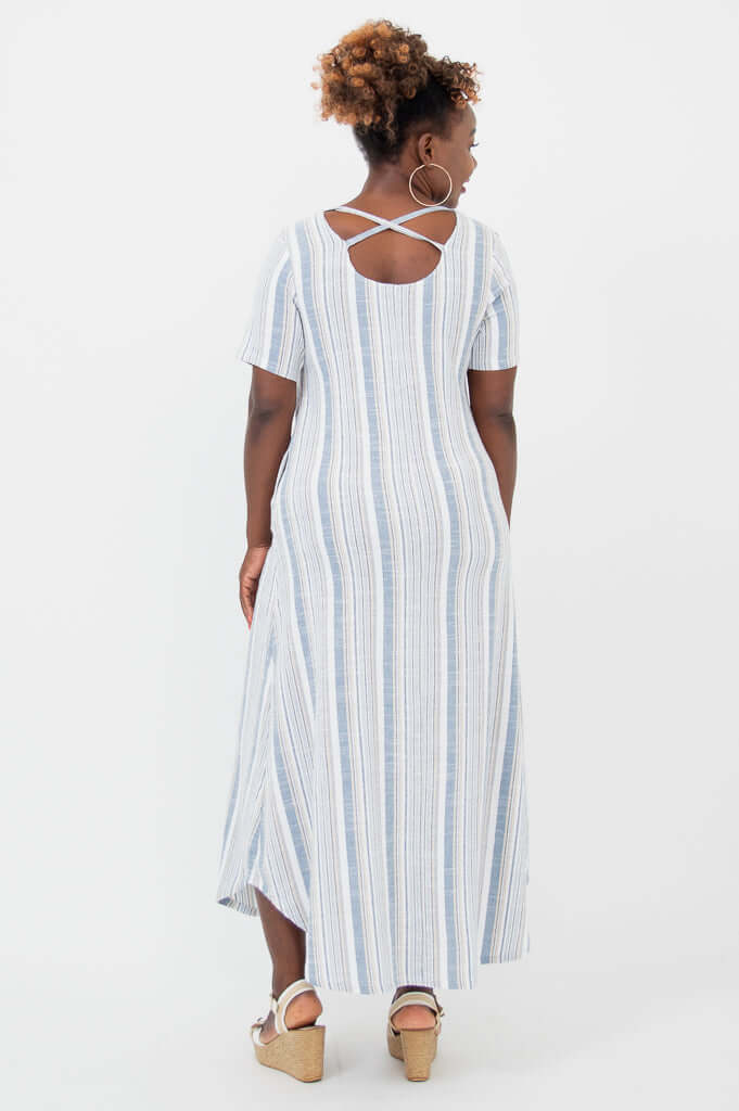 Back view of woman in striped maxi dress showing crisscross strap detail