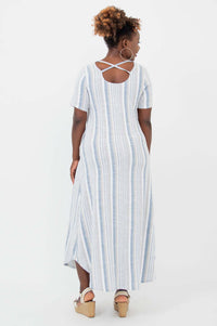 Back view of woman in striped maxi dress showing crisscross strap detail