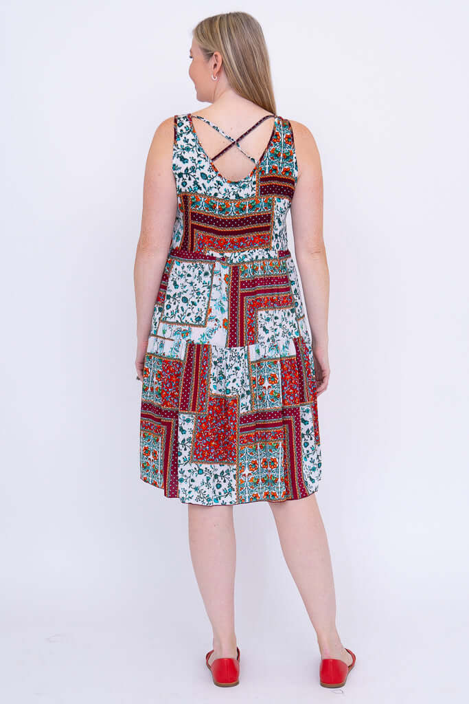 Back view of woman showing criss-cross strap detail on patchwork summer dress