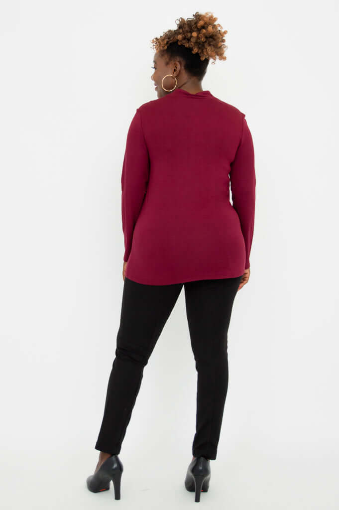 Back view of woman wearing burgundy V-neck bamboo top and black pants