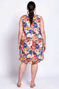 Back view of a woman wearing a sleeveless dress with bold floral print in orange, blue, and cream