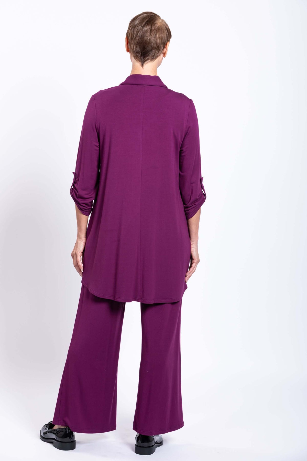 Back view of model in plum bamboo tunic blouse and matching pants