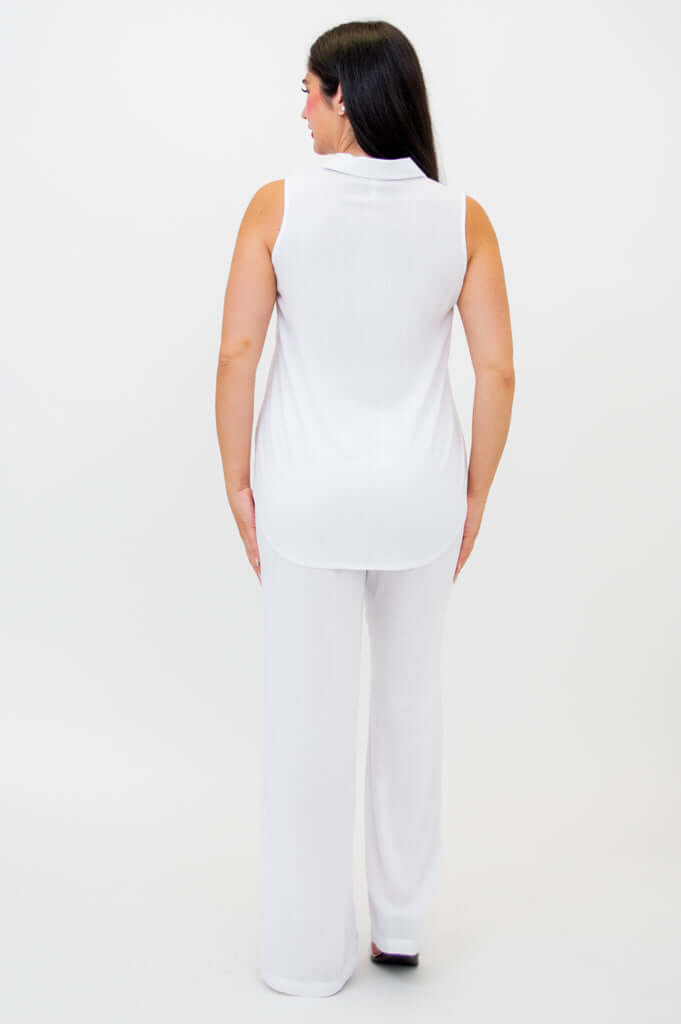 Back view of woman in white sleeveless tank and wide-leg pants