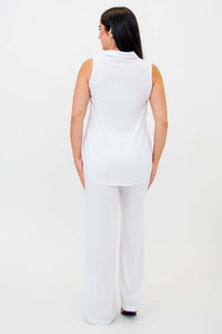 Back view of woman in white sleeveless tank and wide-leg pants