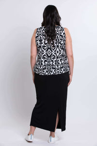 Back view of model in sleeveless Ikat print tank top with black skirt