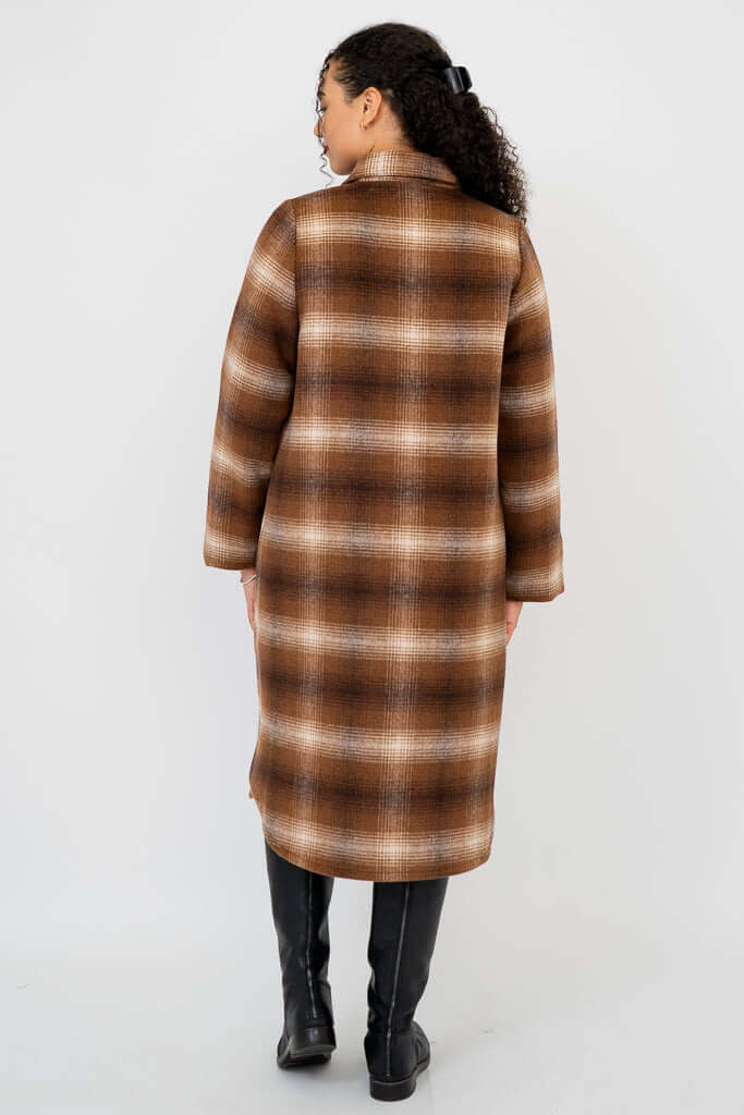 Back view of model highlighting the plaid pattern and straight hem of coat