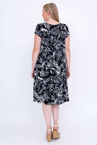 Back view of black and white leafy print dress showcasing the relaxed fit