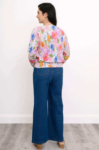 Rear view of woman wearing floral print cardigan and blue wide-leg denim pants