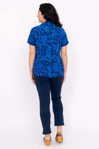 Back view of woman wearing Aida Top in blue swirl pattern