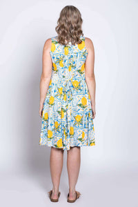 Model wearing Arden dress with lemon tile print, showing rear tie detail, back view