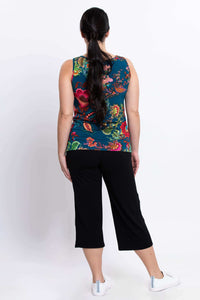 Back view of woman in floral bamboo tank top with black pants