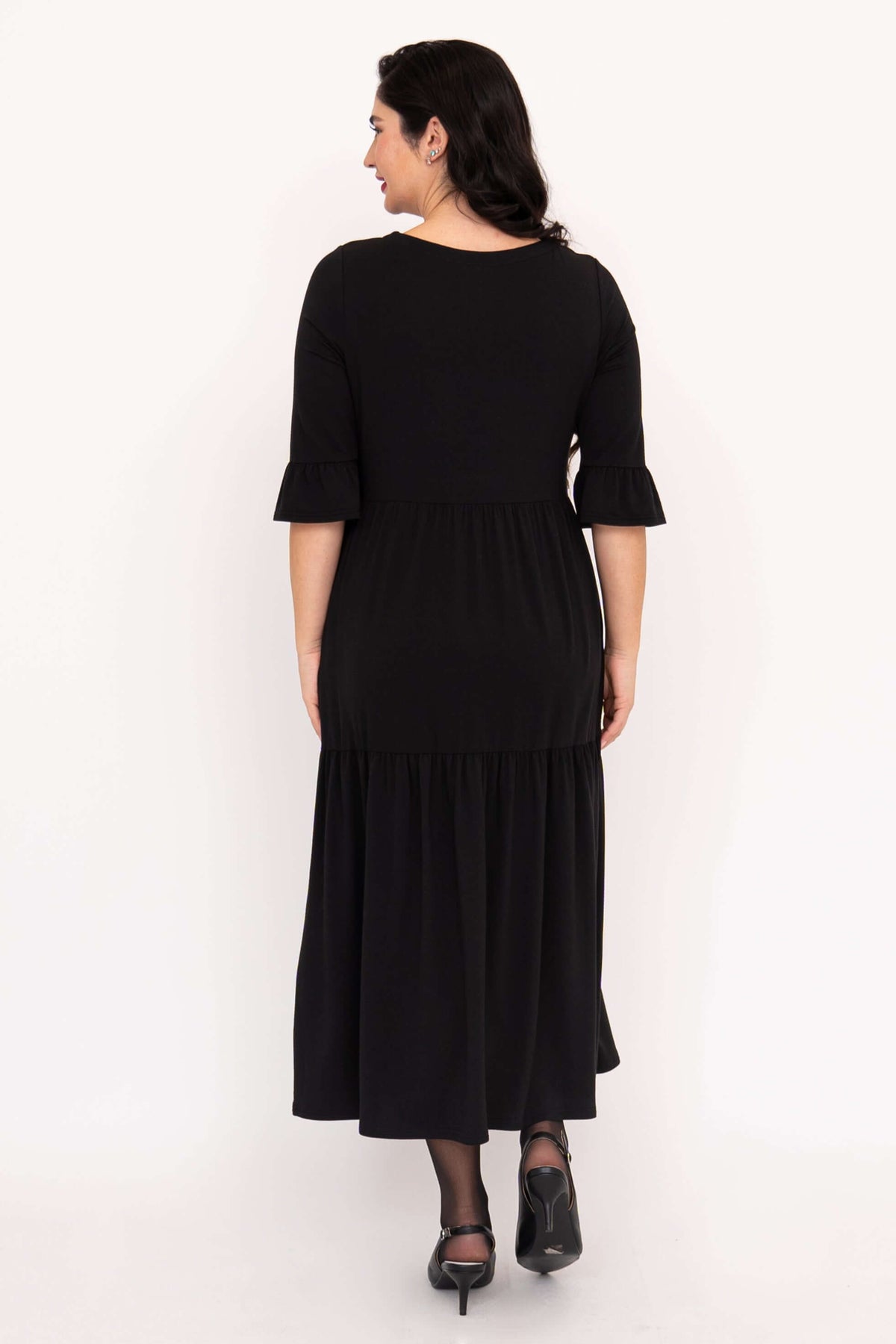 Back view of woman wearing black tiered Bernadette Long Dress with ruffle sleeves