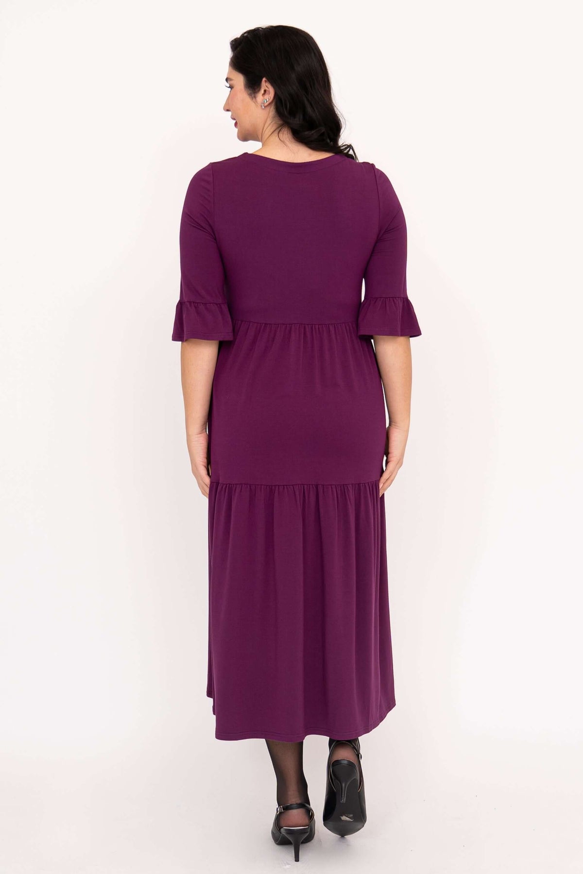Back view of purple Bernadette long dress showing ruffled sleeve and gathered skirt detail