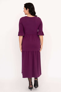 Back view of purple Bernadette long dress showing ruffled sleeve and gathered skirt detail