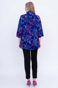 Back view of woman wearing blue and purple floral tunic with 3/4 sleeves