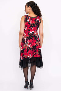 Back view of woman in sleeveless red floral dress with mesh hem