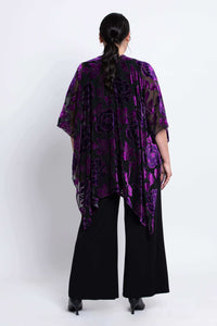 Back view of a woman wearing a black and purple velvet burnout kimono wrap