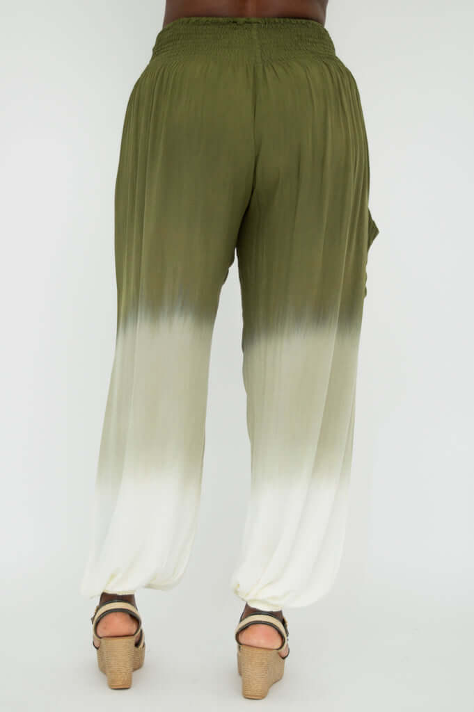 Back view of olive to cream ombre pants with gathered details, model in wedge sandals