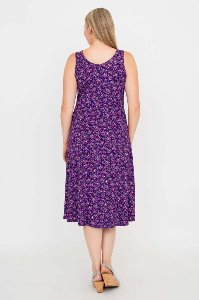 Rear view of a woman in a purple floral sleeveless tank dress highlighting the back design