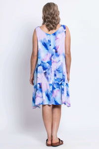Back view of woman showcasing ruffle detail on watercolor linen bamboo dress