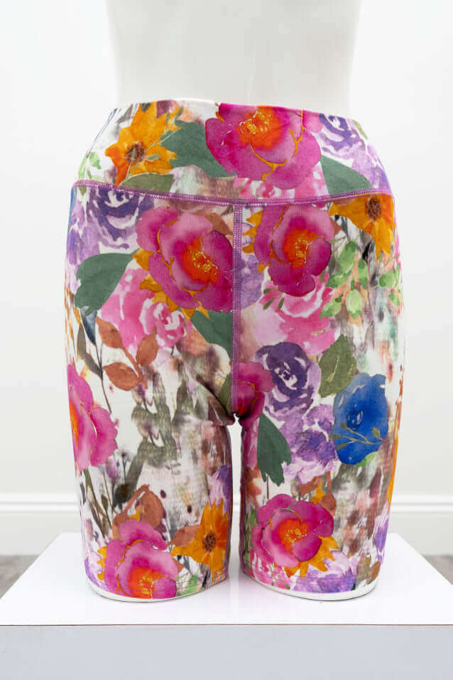 Back view of Hallie Bamboo shorts with colorful floral print on mannequin