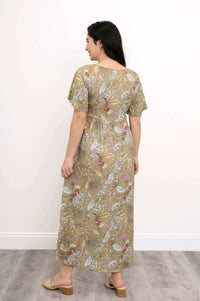 Back view of woman wearing green floral Jane empire waist maxi dress